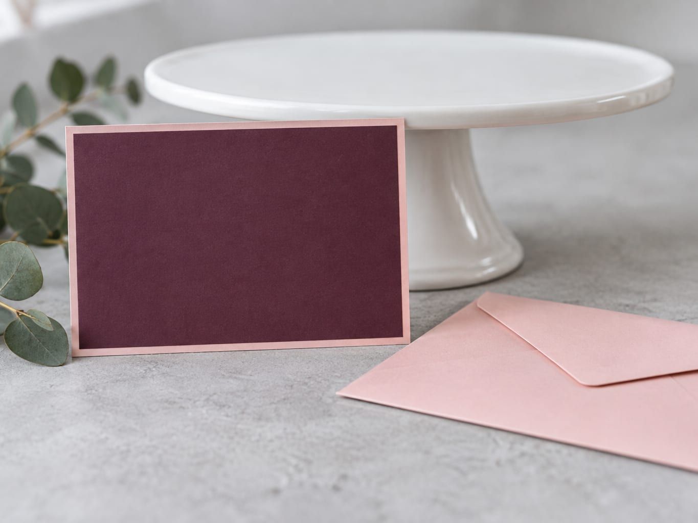 Printed gift voucher card propped against a cake stand